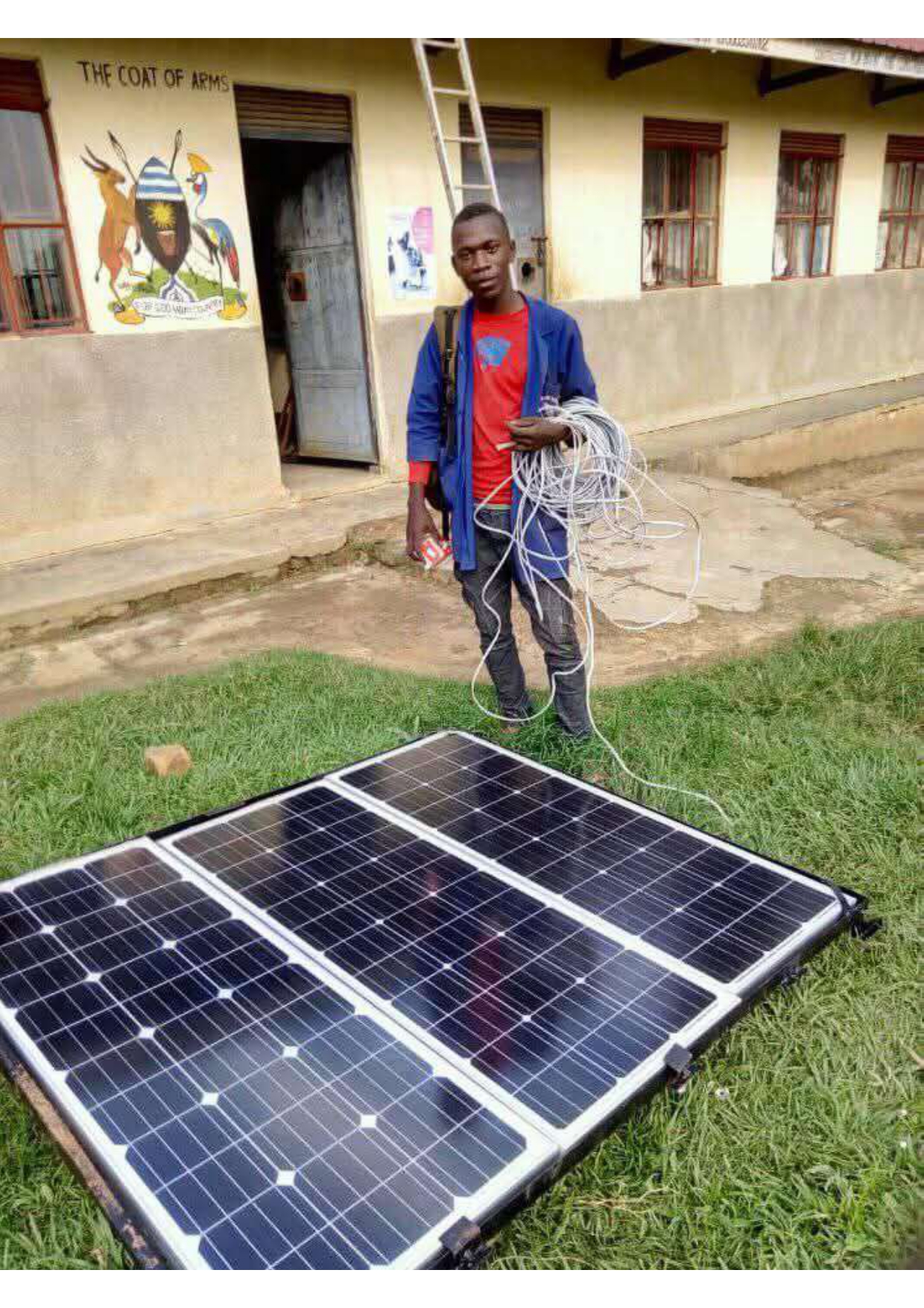 Technician installing solar panel for classroom lighting